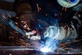 Employee welding steel with sparks using mig mag welder - focus on sparks Royalty Free Stock Photo
