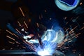 Employee welding steel with sparks using mig mag welder - focus on sparks Royalty Free Stock Photo