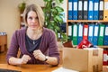 Employee woman is absolutely furious about lost her job, sitting in workplace with carton box with things