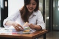 Employee woman hands working in stacks paper files for searching and checking unfinished document achieves on folders Royalty Free Stock Photo