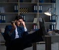 Employee working late and drinking strong coffee to stay awake