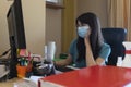 Employee works in the office with the mask to prevent infection during the virus quarantine