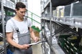 Employees of a car repair shop in a warehouse for spare parts - Royalty Free Stock Photo