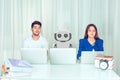 Employees with colleagueÃ¢â¬Â robot spying at workplace