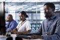 Employees in data center deploying and error checking utilities on computer Royalty Free Stock Photo