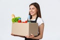 Employees, delivery and online orders, grocery stores concept. Profile of nice cute saleswoman, cashier in black apron