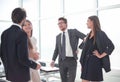 Employees discuss something standing in the office Royalty Free Stock Photo