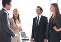 Employees discuss something standing in the office Royalty Free Stock Photo
