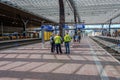 Employees of the Dutch railways inform a passenger on a platform