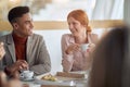 Employees enjoying coffee together at lunch break at company canteen. People, job, company, business concept Royalty Free Stock Photo