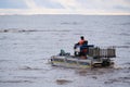 Employees of the environmental service clean up after low tide on the coast Gulf of Finland remove garbage, oil spills, harmful