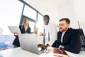 Employees of financial corporation watch the growth of their company`s shares on a laptop. Royalty Free Stock Photo