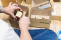 Employees are packing a parcel in the send to the customer.