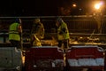 Employees of the road service in special yellow vests perform work on the repair of the roadway. Restoration of the deformation