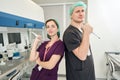 Employees of scientific laboratory stand at their workplace with pipettes Royalty Free Stock Photo