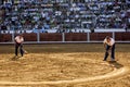 Employees of the service from the plaza de toros de Pozoblanco smoothing the sand with a rake in Pozoblanco Royalty Free Stock Photo