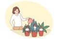 Manager watering small employees in pots