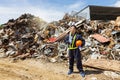 Employees standing in recycling center outdoors. Engineer working at a pile of scrap metal recycling and recycling industry