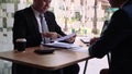 Employees are submitting their resume to friendly interviewers while reading their resume at the interview room