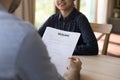 Employer reading paper resume on job interview, listening to candidate Royalty Free Stock Photo