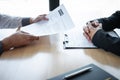 Employer or recruiter holding reading a resume during about colloquy his profile of candidate, employer in suit is conducting a Royalty Free Stock Photo