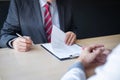 Employer or recruiter holding reading a resume during about colloquy his profile of candidate, employer in suit is conducting a Royalty Free Stock Photo