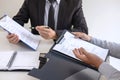 Employer or recruiter holding reading a resume during about colloquy his profile of candidate, employer in suit is conducting a