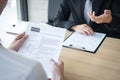 Employer or recruiter holding reading a resume during about colloquy his profile of candidate, employer in suit is conducting a