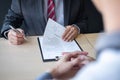 Employer or recruiter holding reading a resume during about colloquy his profile of candidate, employer in suit is conducting a Royalty Free Stock Photo