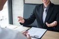 Employer or recruiter holding reading a resume during about colloquy his profile of candidate, employer in suit is conducting a Royalty Free Stock Photo