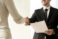 Employment handshake closeup, employer shaking new hire hand, of