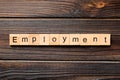 Employment word written on wood block. Employment text on wooden table for your desing, Top view concept Royalty Free Stock Photo