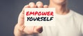 EMPOWER YOURSELF, message on the card shown by a man Royalty Free Stock Photo
