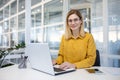 Empowered businesswoman with a happy smile at her desk