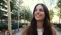 Empowered happy young woman walking in a city