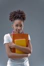 Empowered knowledge-seeker hugs books with determination