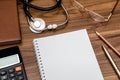 Empry notepad with stethoscope, euro money, glasses, pen, calculator Royalty Free Stock Photo