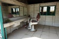 An empty and abandoned small wooden barber shop.