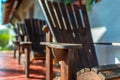 Empty adirondack arm chairs in row on wood deck Royalty Free Stock Photo