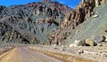 Empty adventurous lonely dirt road on the chilean pacific coast between rough rugged rocks in lonely dry desert area - Pan de Royalty Free Stock Photo