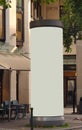 Empty advertising pillar in a city with grey free copy space, promotion mock up. Blank advertising panel