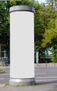 Empty advertising pillar in a city with white free copy space, promotion mock up. Blank advertising panel