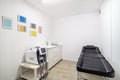 Empty aesthetic medicine salon. Modern empty dermatologist cosmetologist massage table for procedures in the beauty