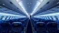 Spacious airplane interior with rows of blue seats. Comfortable cabin ready for passengers on a commercial flight. Air Royalty Free Stock Photo