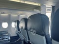 Empty airplane cabin interior showing passenger seats and windows Royalty Free Stock Photo