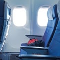 Empty airplane seats, tranquil windows, inviting comfort in budget travel