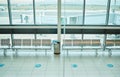 Empty airport, chair or furniture in departure lounge, covid compliance or coronavirus lockdown in global healthcare Royalty Free Stock Photo