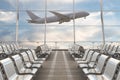 Empty airport departure lounge with airplane on background.