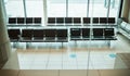 Empty airport, seats or furniture in departure lounge, covid compliance or coronavirus lockdown in global healthcare Royalty Free Stock Photo