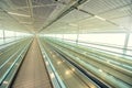 Empty airport terminal due to coronavirus pandemic and suspended airline flights. Empty airport terminal. Mechanical corridor with